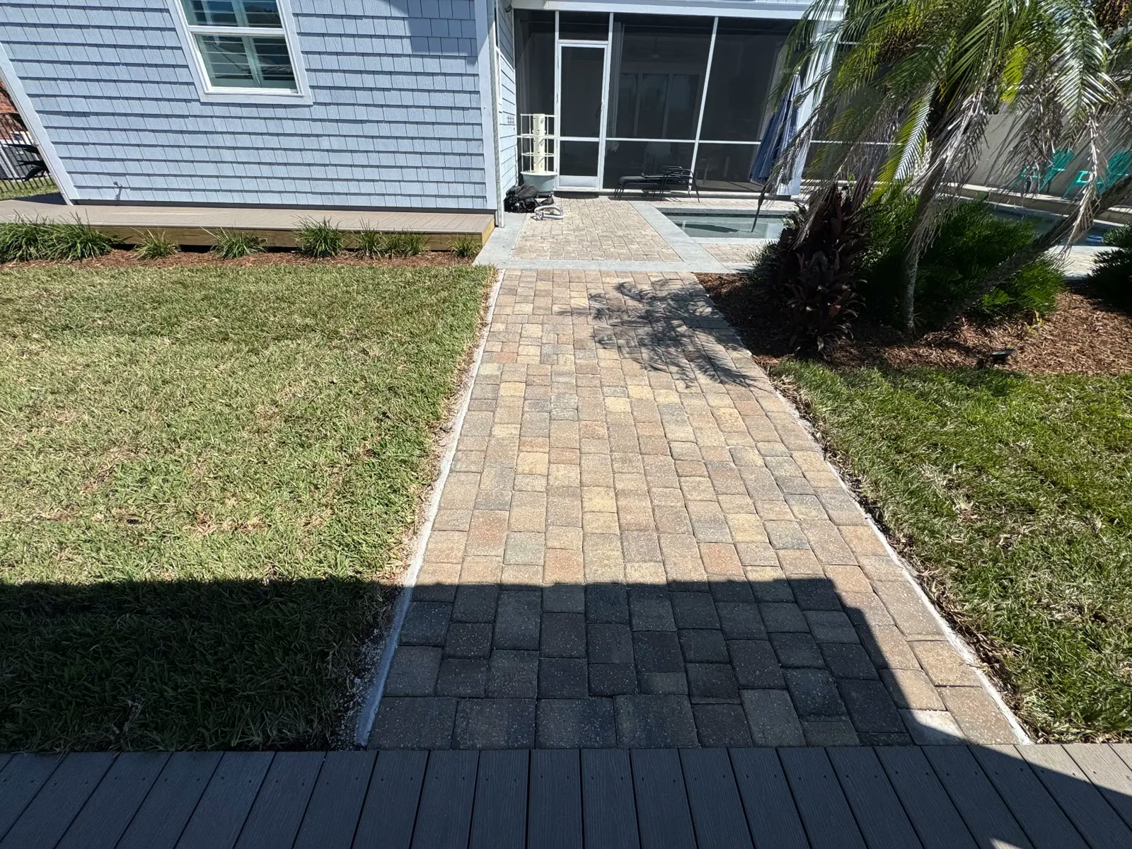 Dock walkway with fresh landscaping and palms