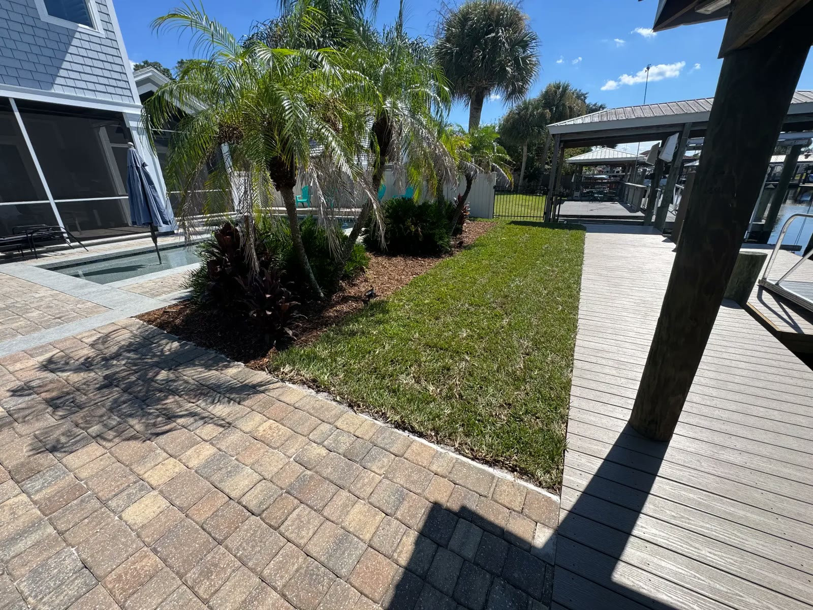 Landscaped yard leading down to the boathouse